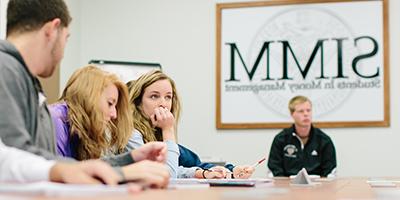 Students conferring during a SIMM meeting